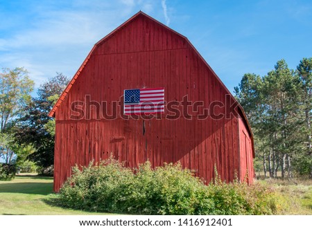 Terrific old red barn with an American Flag displayed on one end.