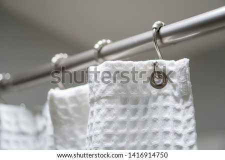 Decorative luxurious shower curtain on hooks. Royalty-Free Stock Photo #1416914750