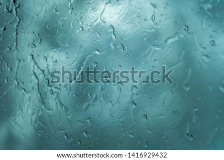 Rain drops on car window, wet glass,  rainy day.