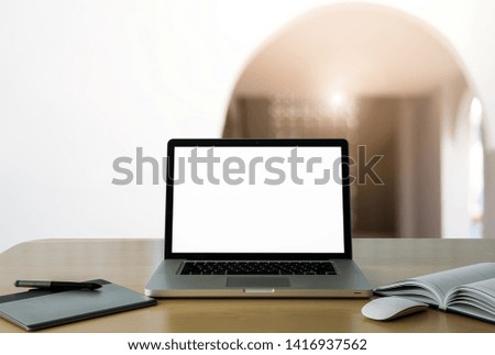 Workspace wooden desk with Mockup Laptop with blank screen and wireless mouse and graphics tablet and notebook ,interior or room home blurred background. - Image