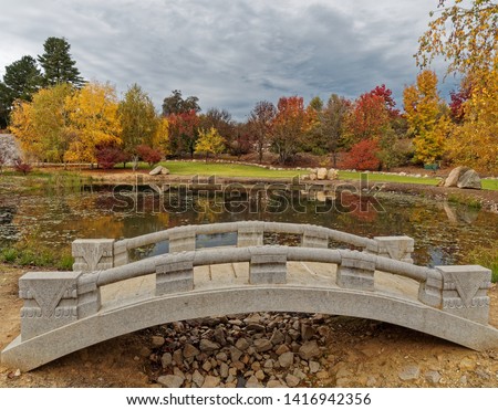 Park with colourful Autumn trees, Lake and bridge. Beechworth,  Victoria,  Australia.