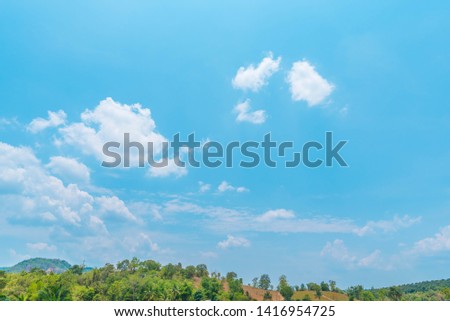 Beautiful Blue Sky Background with White Clouds and Mountains. Picture for Summer Season.