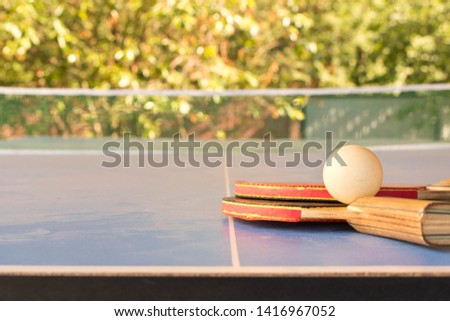 Table tennis rackets and a ball on the table