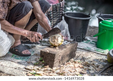 Blurred background of people who are stripping coconut balls, there are many species Flavor, sweetness, drinking and refreshing body is a popular fruit grown in rural homes.