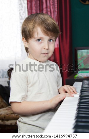 Little boy Learn to play the synthesizer, home music training