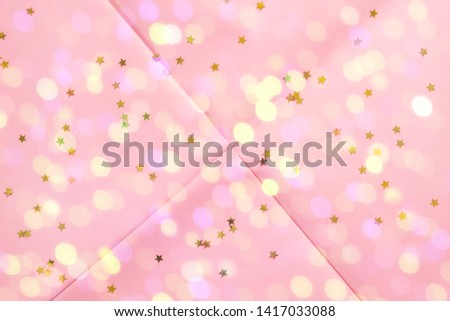 Pink coral wrapping paper background with star confetti and sparkle lights. Geometry festive abstract art concept backdrop.