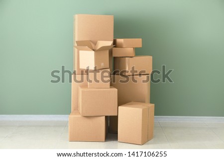 Cardboard boxes near color wall