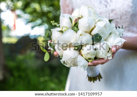 Close up of white wedding bouquet with peonies
