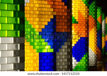Blurred colorful of glass blocks in different colors to decorate on wall and column of the building.Abstract geometric  background.