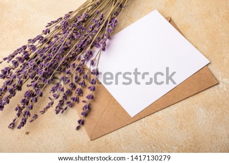 Blank paper with Kraft envelope and lavender flowers on a light background. Clean postcard for your signatures. Simple Wedding Arrangement