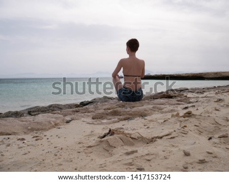 Young woman in bikini on the shore