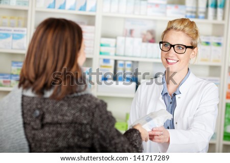 Female customer buying medicine at the pharmacy Royalty-Free Stock Photo #141717289