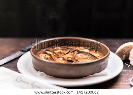 ceramic gastronomic dish of mussels with sauce
