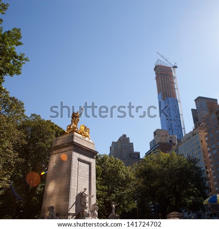 The historic golden Maine monument statue located in Colombus Circle at the south entrance of Central Park in New York City Manhattan.