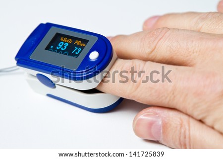 A pulse oximeter used to measure pulse rate and oxygen levels Royalty-Free Stock Photo #141725839