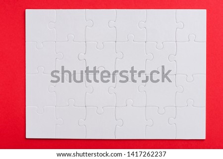 top view of connected white puzzle pieces with copy space isolated on red