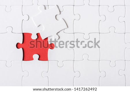 top view of white incomplete jigsaw near puzzle piece Royalty-Free Stock Photo #1417262492