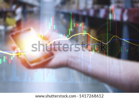 Mobile device in hand monitoring stock market and business gains for finance concept.  Connectivity with live exchange data and intelligence.