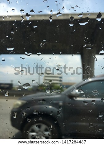 Raindrops attached to the car glass, the view from the car