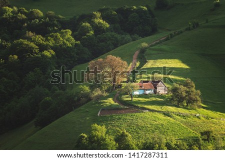 Beautiful summer green hills in Transylvania. Sunrise landscape in the Romanian mountain village Royalty-Free Stock Photo #1417287311