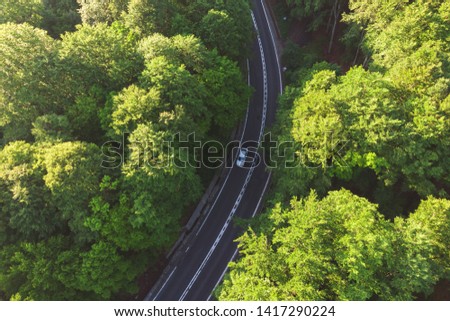 Aerial view of a beautiful mountain road, at sunrise Royalty-Free Stock Photo #1417290224