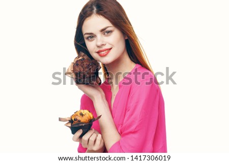 Cute woman pink shirt muffins in the hands of sweets dessert diet
