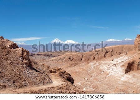 Panorama of Moon Valley (Valle de la Luna) in Atacama desert, snowy Andes mountain range in the background, Los Flamencos National Reserve in northern Chile’s Atacama Desert