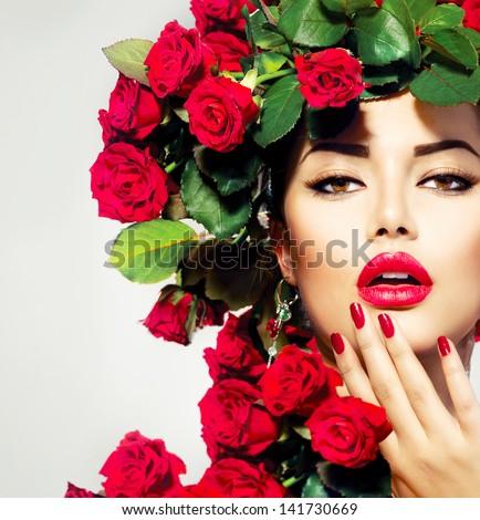 Beauty Fashion Model Girl Portrait with Red Roses Hairstyle. Red Lips and Nails. Beautiful Luxury Makeup and Hair and Manicure Vogue Style Royalty-Free Stock Photo #141730669