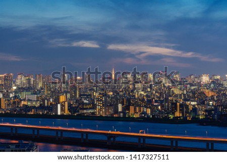 Panoramic View of Tokyo Skyscraper Cityscape under Vivid and Colorful Twilight Sky include Buildings, River, Traffic Road in Business and Financial District of Tokyo and Mount Fuji in Clouds