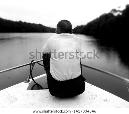 A man on a boat along Sungai Bengkoka, Pitas, Sabah.