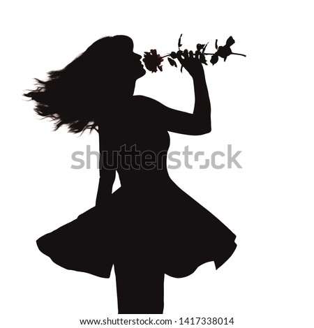 silhouette of a young elegant woman in a dress and with a rose in hands, figure of romantic girl with a flower dancing from happiness on a white isolated background
