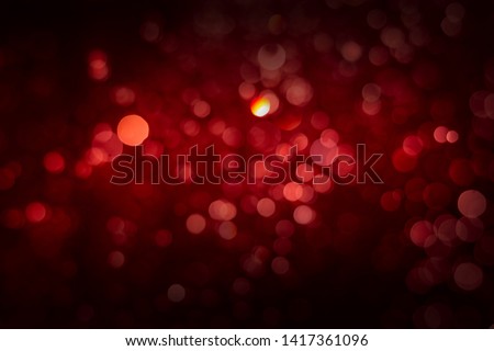 Abstract red background with soft blur bokeh light effect.