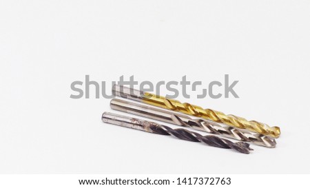 Three drill bits on a white background
