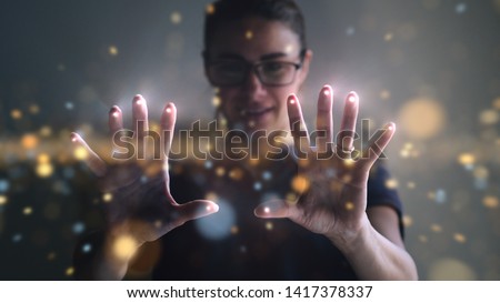 Portrait of an young man is using the futuristic latest innovation technology with augmented reality hologram. Concept of future, innovation, technology, holographic  Royalty-Free Stock Photo #1417378337