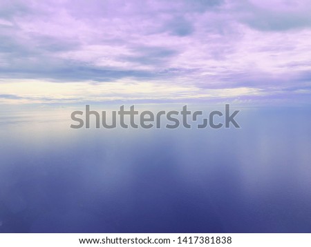 Airplane or helicopter inside cockpit flying over blue cloudy sky or an aerial view of a white fluffy cloud under blue sky. pasterl sky background for motivational text