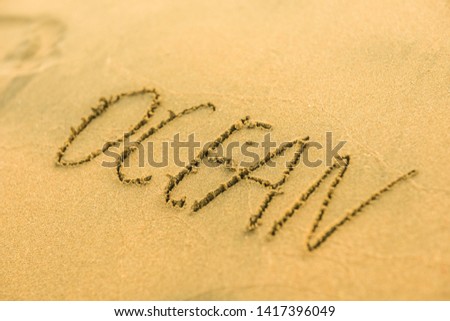 Signs on sand beach written by hand, inspire to travel to exotic islands and relax. Words Ocean, fun, happy and smile on yellow beach. Family tour travel time in summer resort. Enjoy your holidays