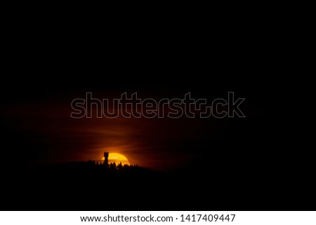 Behind the old Wurmbergturm silhouette, an impressive view during sunrise of the Transit of Venus on June 6th, 2012 seen from the Jordanshöhe mountain, near the town St Andreasberg in Goslar, Germany.