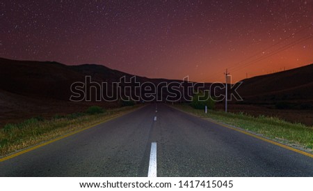 Empty night road over starry sky