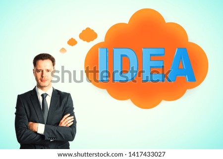 Attractive young european businessman thinking about idea on blue background. Inspire and achieve concept 