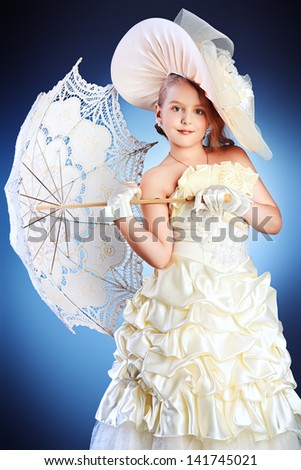 Portrait of a charming little lady in a beautiful elegant dress.