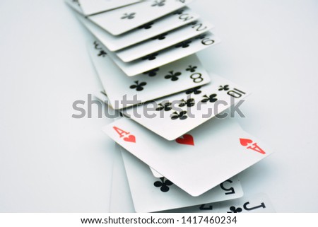 Ace of hearts standing out among several poker cards