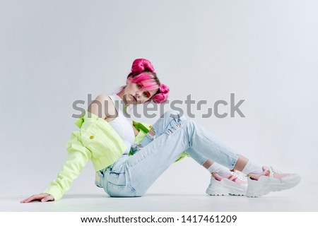 woman with pink hair in green clothes