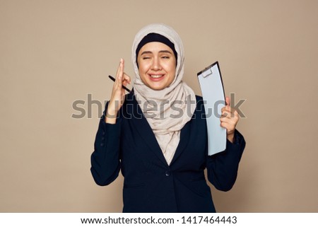woman in a veil holding a tablet folder                               