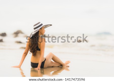 Portrait beautiful young asian woman wear bikini on the beach sea ocean for leisure relax in holiday vacatiom time