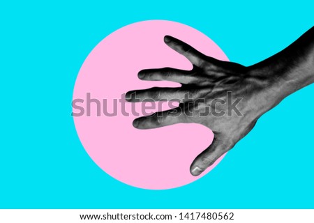 Isolated on blue background black and white man hand photo on pink circle. Surrealistic collage style, contemporary art element for design, posters and banners. Cotton candy pop colors. Magazine style