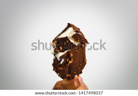 close up of hand holding an Eskimo with nuts isolated