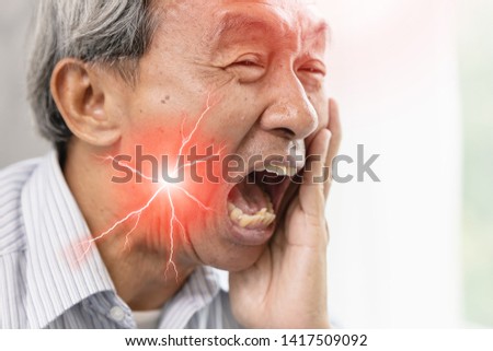 Elder man with severe toothache and hypersensitive teeth.decayed tooth painful face expression. Royalty-Free Stock Photo #1417509092