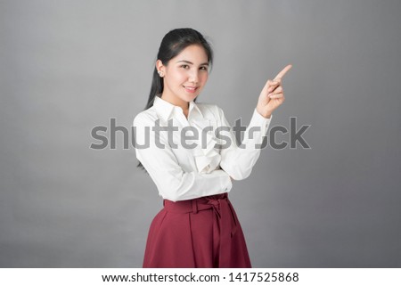 Portrait of beautiful  business woman on grey background, studio shot 