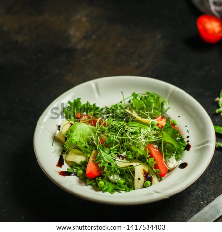 salad vegetables - tomato, lettuce, cheese, microgreen and salad dressing. food background. top