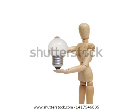 Wooden mannequins figure puppet Poses holding a 
Light bulb isolated on white background